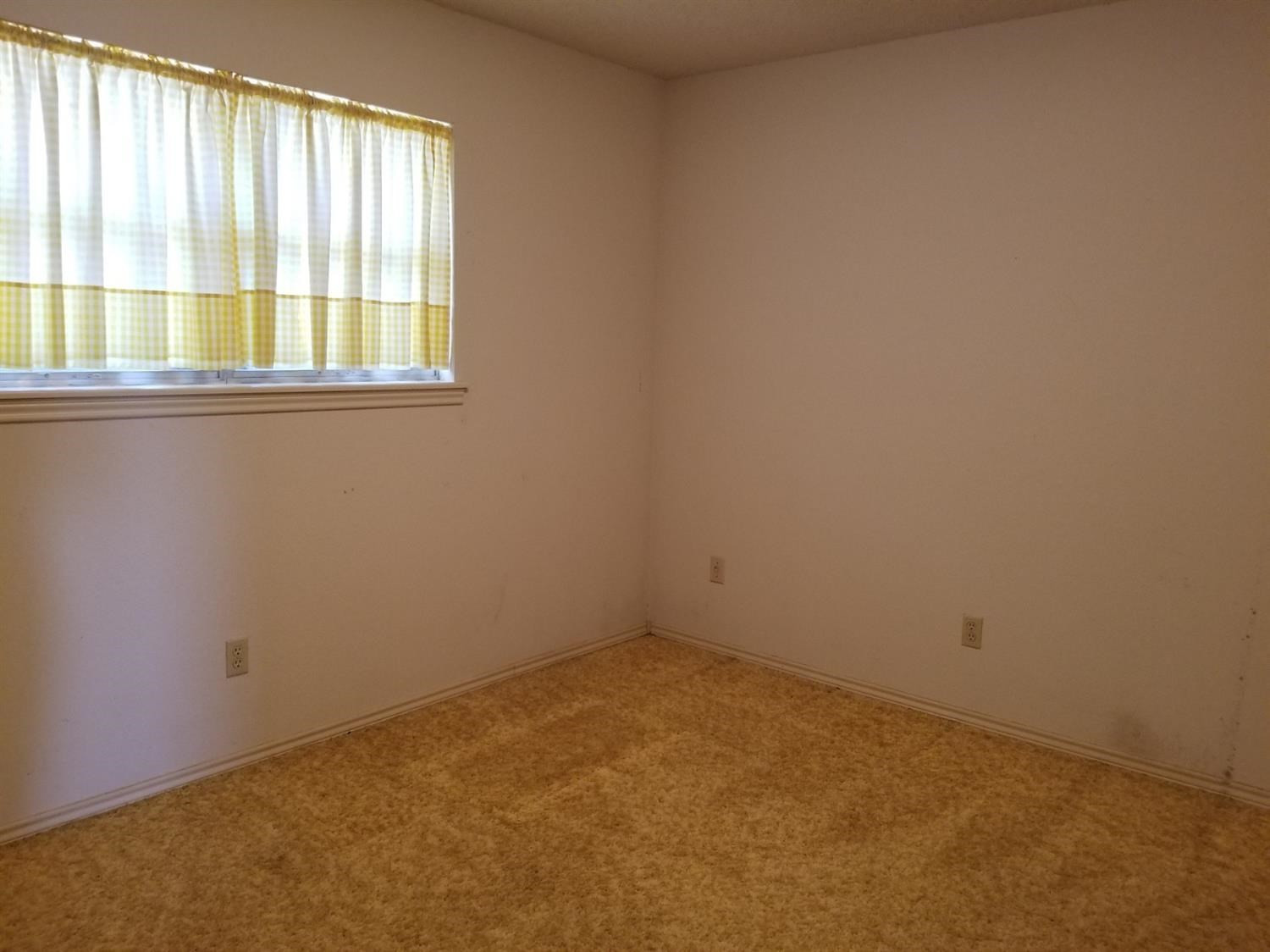 5314 22nd Street Lubbock, TX 79407 - Photo 9 of 10 an empty room with a window