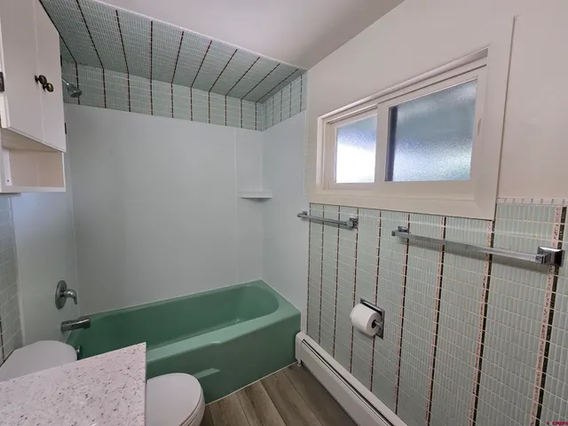 a bathroom with a shower a toilet and a sink