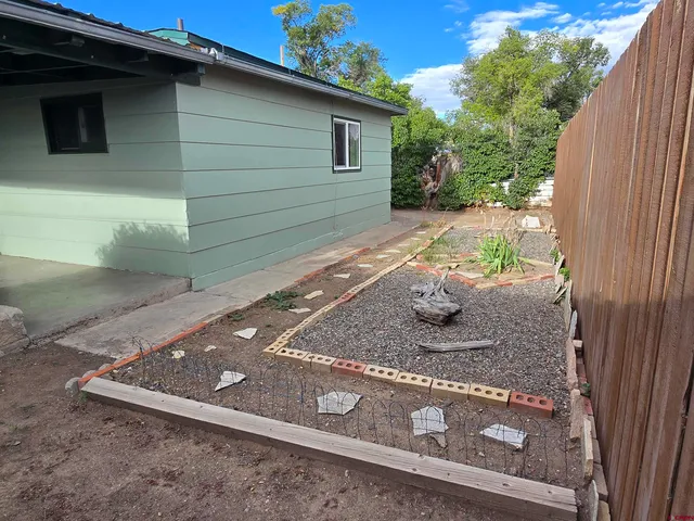 a view of a backyard with a tree