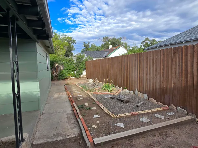 a view of a backyard with sitting area
