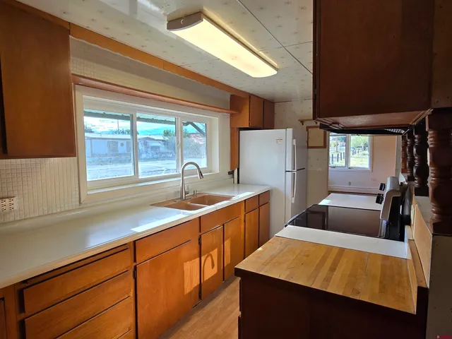 a kitchen with refrigerator and cabinets