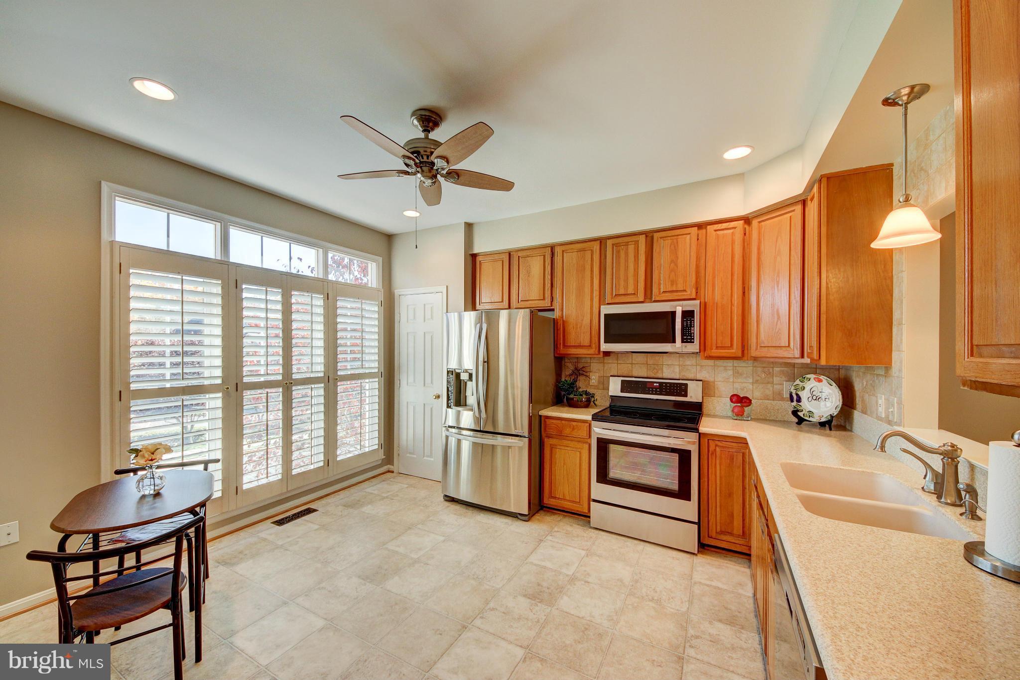 1258 Weatherstone Court Reston, VA 20194 - Photo 2 of 24 a kitchen with stainless steel appliances a stove a sink and a refrigerator