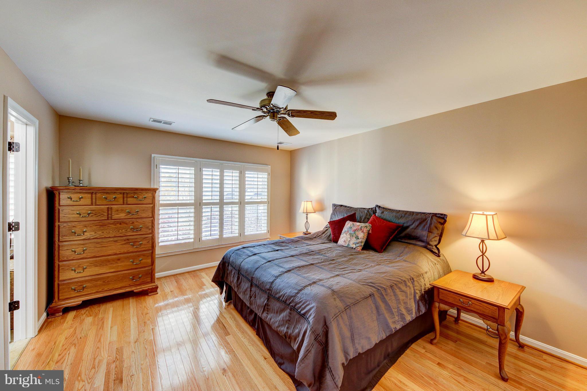 1258 Weatherstone Court Reston, VA 20194 - Photo 11 of 24 a bedroom with a bed a dresser and a window