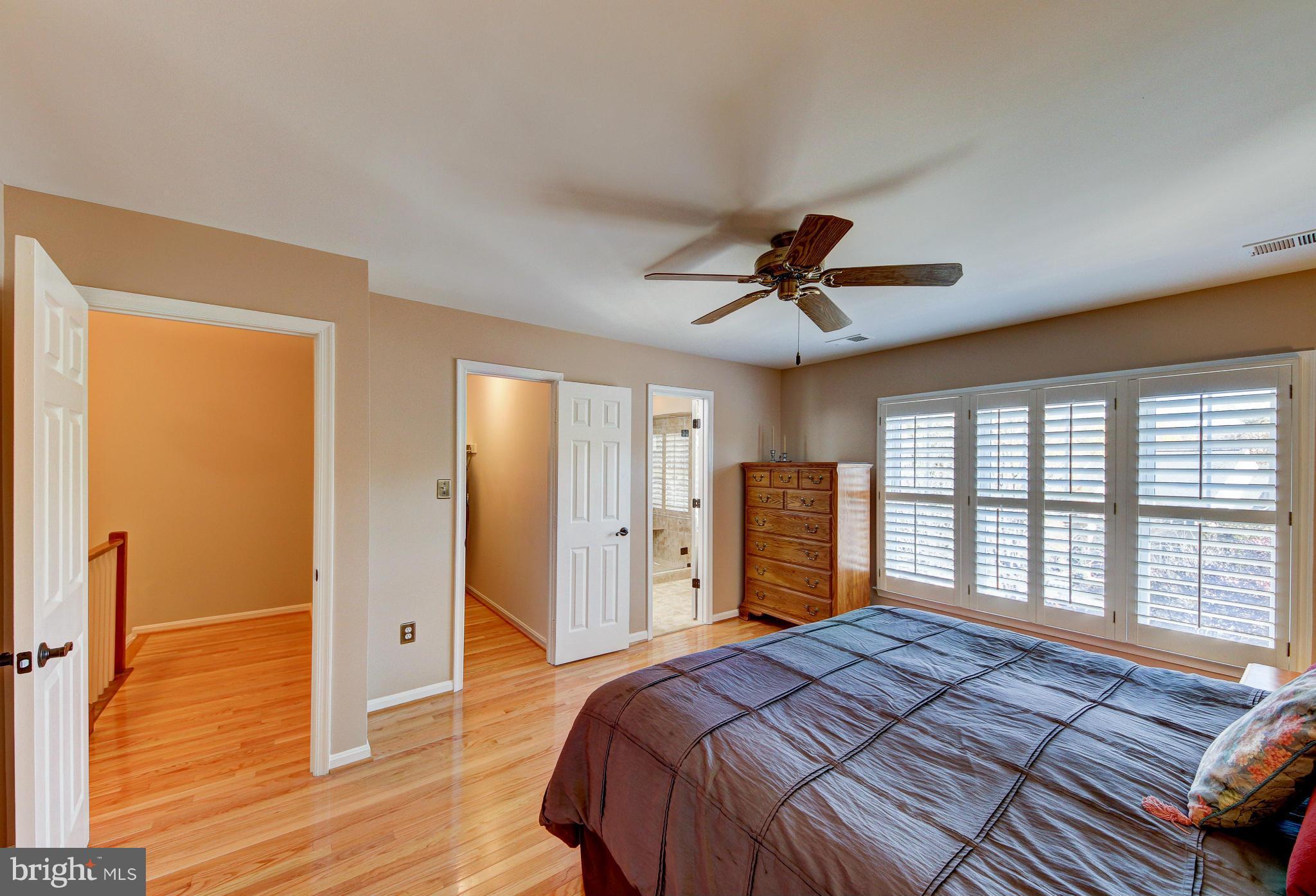 1258 Weatherstone Court Reston, VA 20194 - Photo 13 of 24 a bedroom with a bed and a chandelier