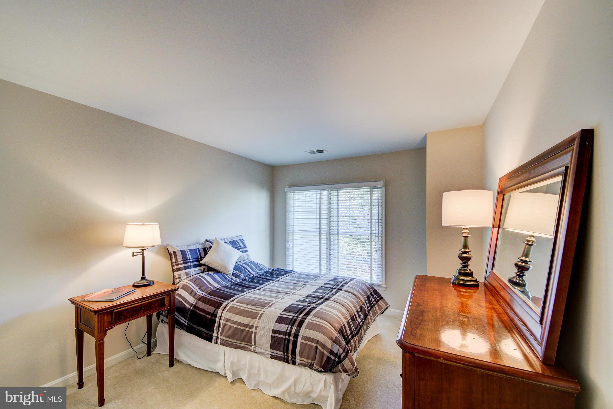 1258 Weatherstone Court Reston, VA 20194 - Photo 17 of 24 a bedroom with a bed and a mirror