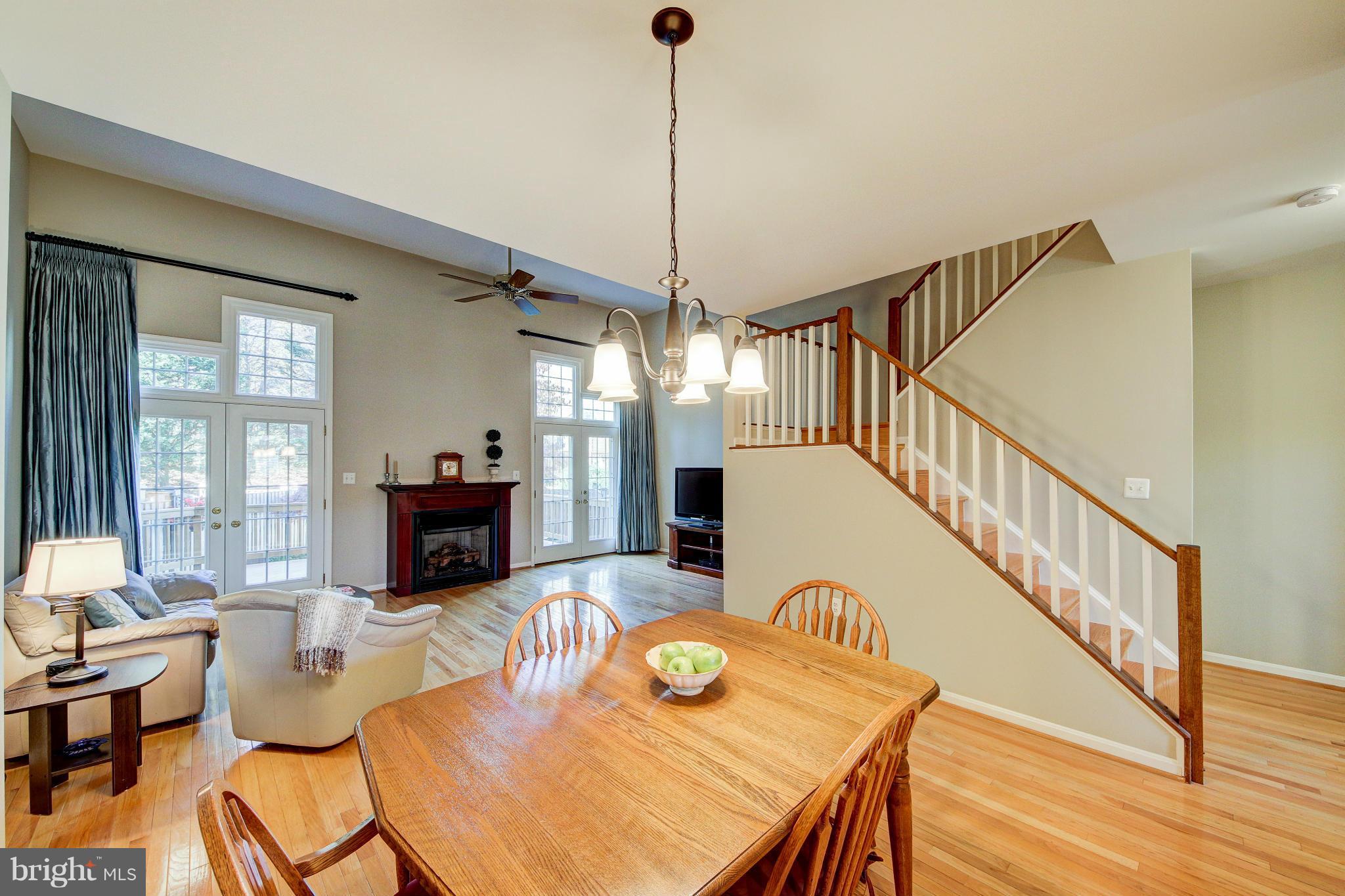 1258 Weatherstone Court Reston, VA 20194 - Photo 4 of 24 a dining room with furniture a rug and wooden floor