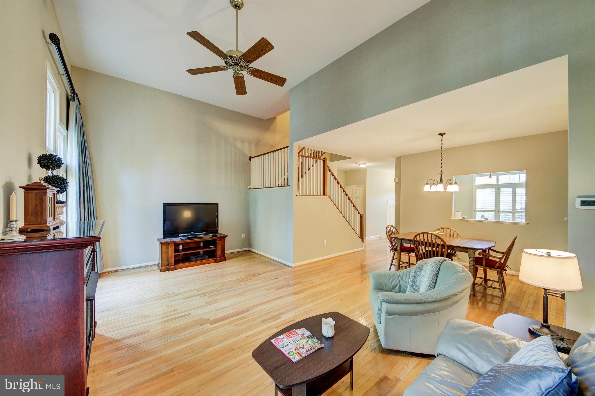 1258 Weatherstone Court Reston, VA 20194 - Photo 7 of 24 a living room with furniture a window and a flat screen tv