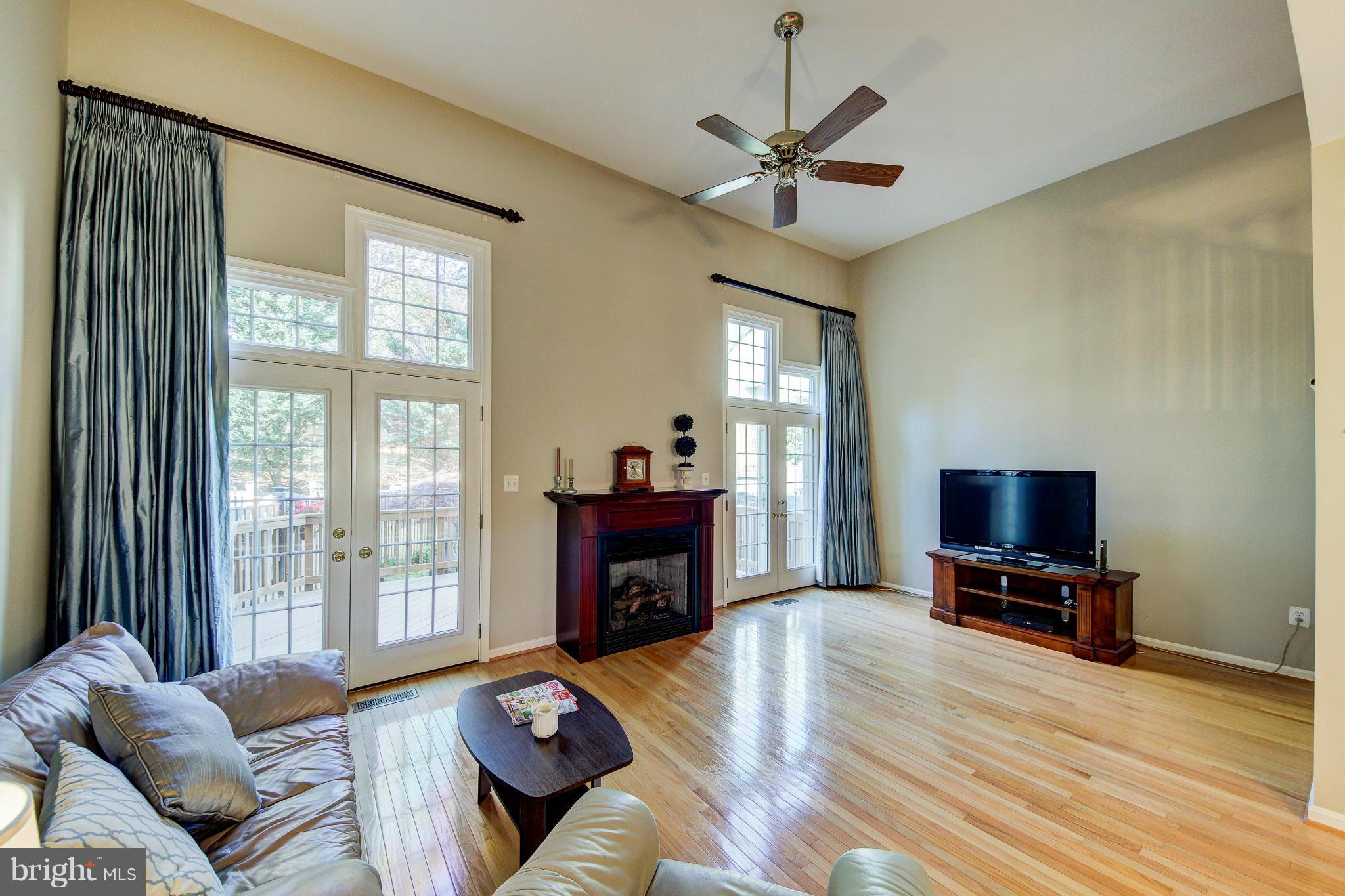 1258 Weatherstone Court Reston, VA 20194 - Photo 8 of 24 a living room with furniture and a flat screen tv