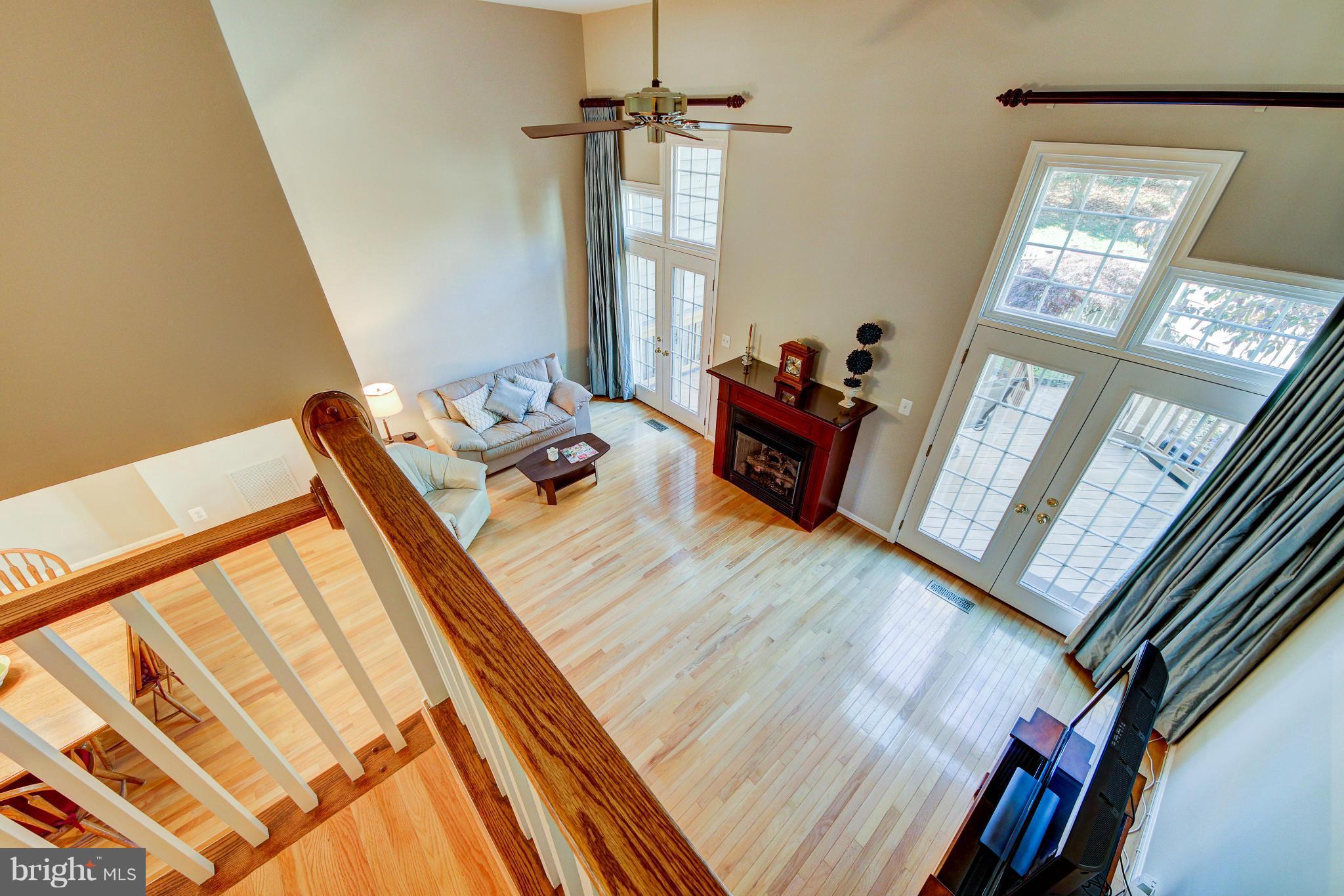 1258 Weatherstone Court Reston, VA 20194 - Photo 10 of 24 a living room with furniture and a floor to ceiling window