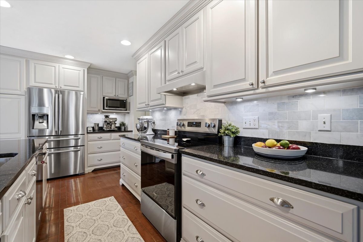 1629 Cheyenne Lane Normal, IL 61761 - Photo 12 of 26 a kitchen with stainless steel appliances granite countertop a sink a stove and cabinets