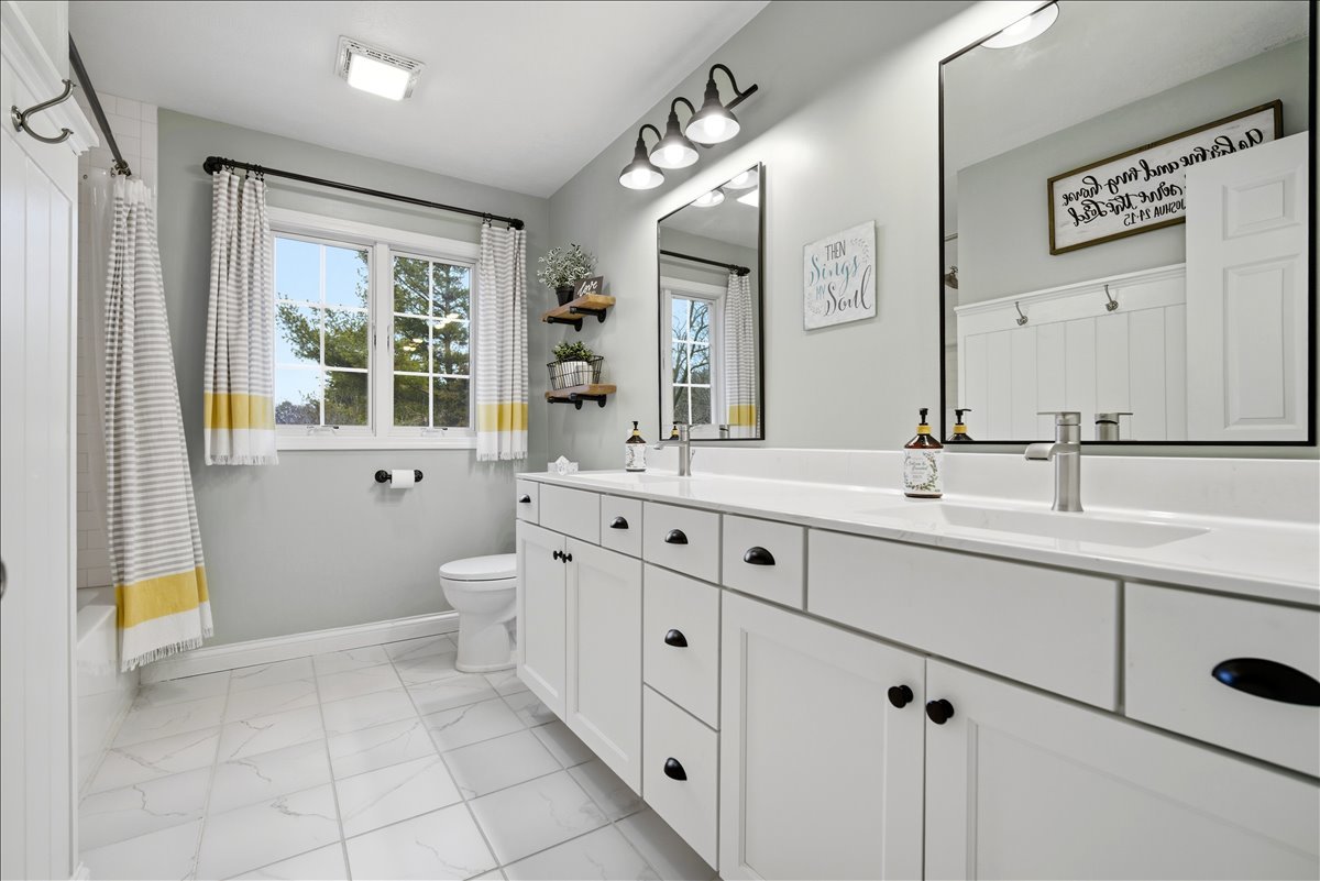 1629 Cheyenne Lane Normal, IL 61761 - Photo 20 of 26 a spacious bathroom with a double vanity sink a mirror and a bathtub