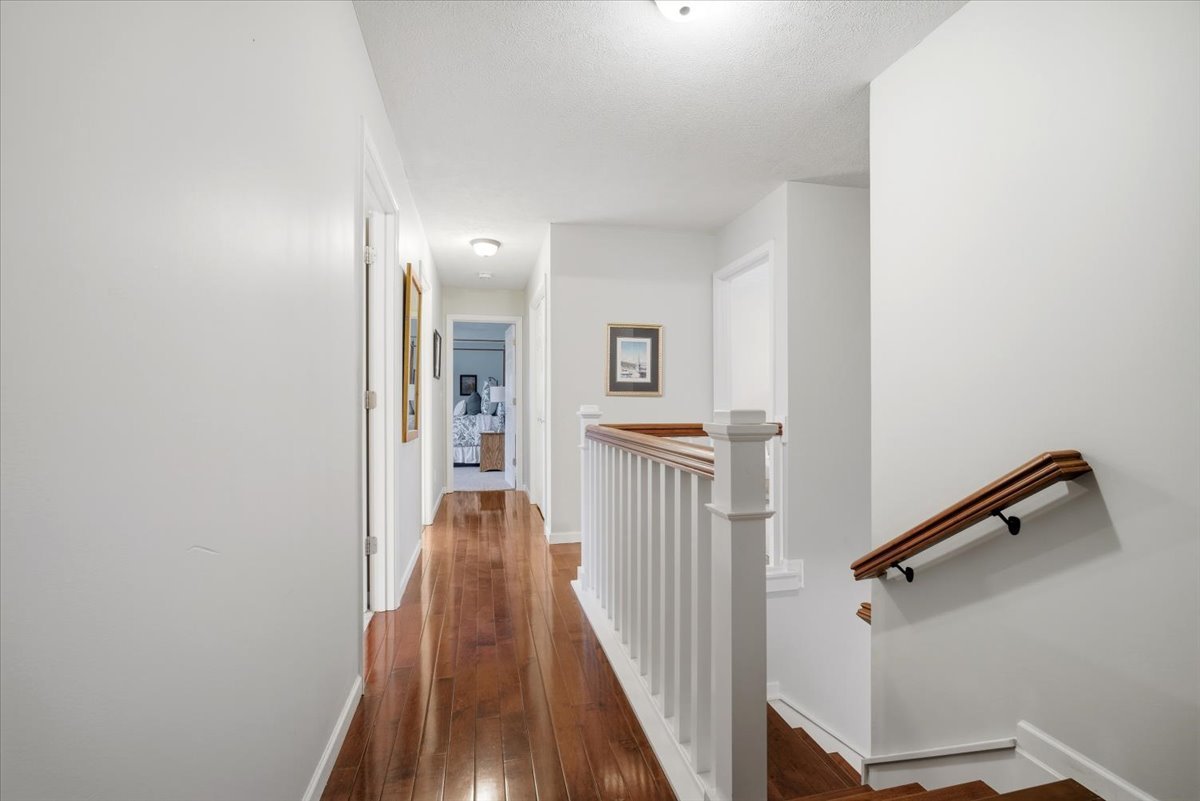 1629 Cheyenne Lane Normal, IL 61761 - Photo 22 of 26 a view of a hallway with wooden floor and staircase