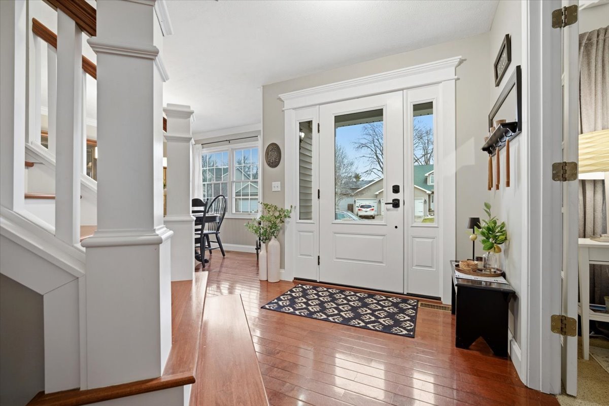 1629 Cheyenne Lane Normal, IL 61761 - Photo 5 of 26 a view of a hallway with wooden floor and dining room
