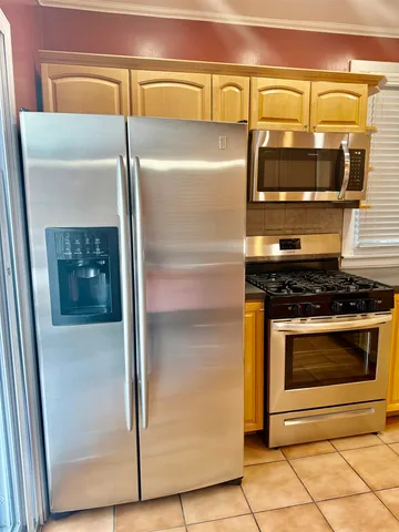 a stove top oven sitting inside of a kitchen