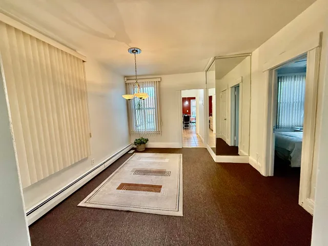 a view of a livingroom with wooden floor and staircase