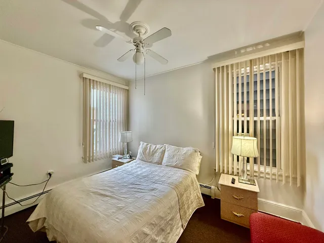 a bathroom with a toilet a sink a mirror and a faucet