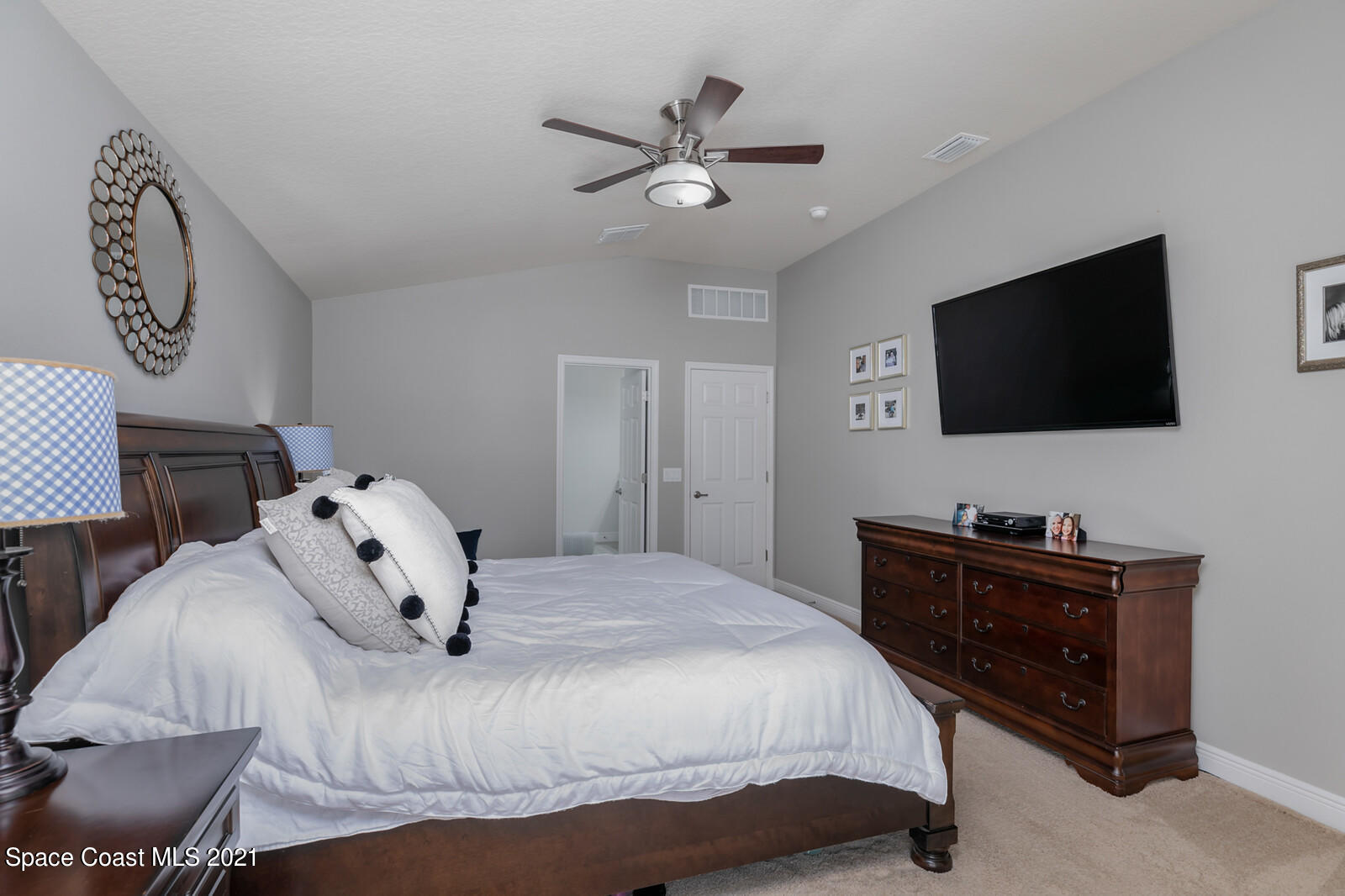 1398 Outrigger Circle Rockledge, FL 32955 - Photo 18 of 51 a bedroom with a bed and a flat screen tv