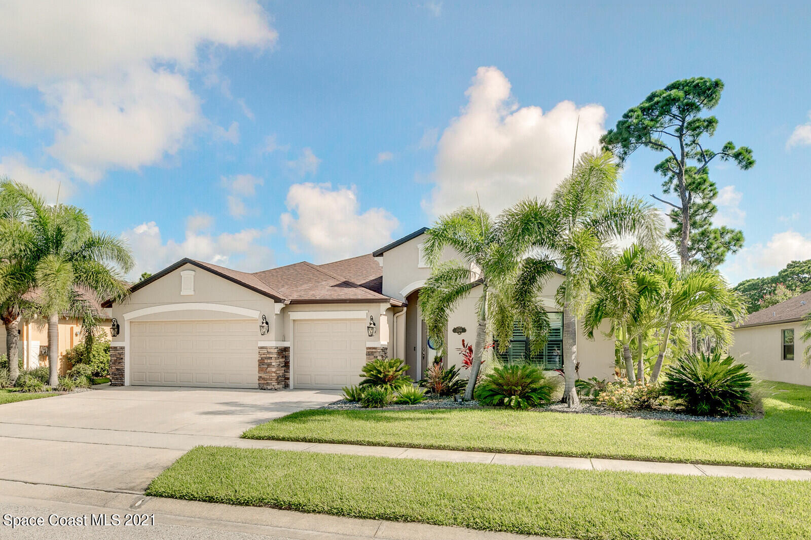 1398 Outrigger Circle Rockledge, FL 32955 - Photo 3 of 51 a front view of a house with a garden and trees