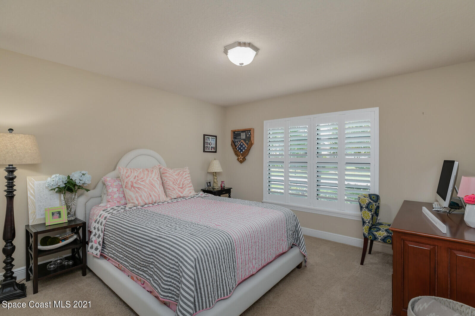1398 Outrigger Circle Rockledge, FL 32955 - Photo 22 of 51 a bedroom with a bed and a desk