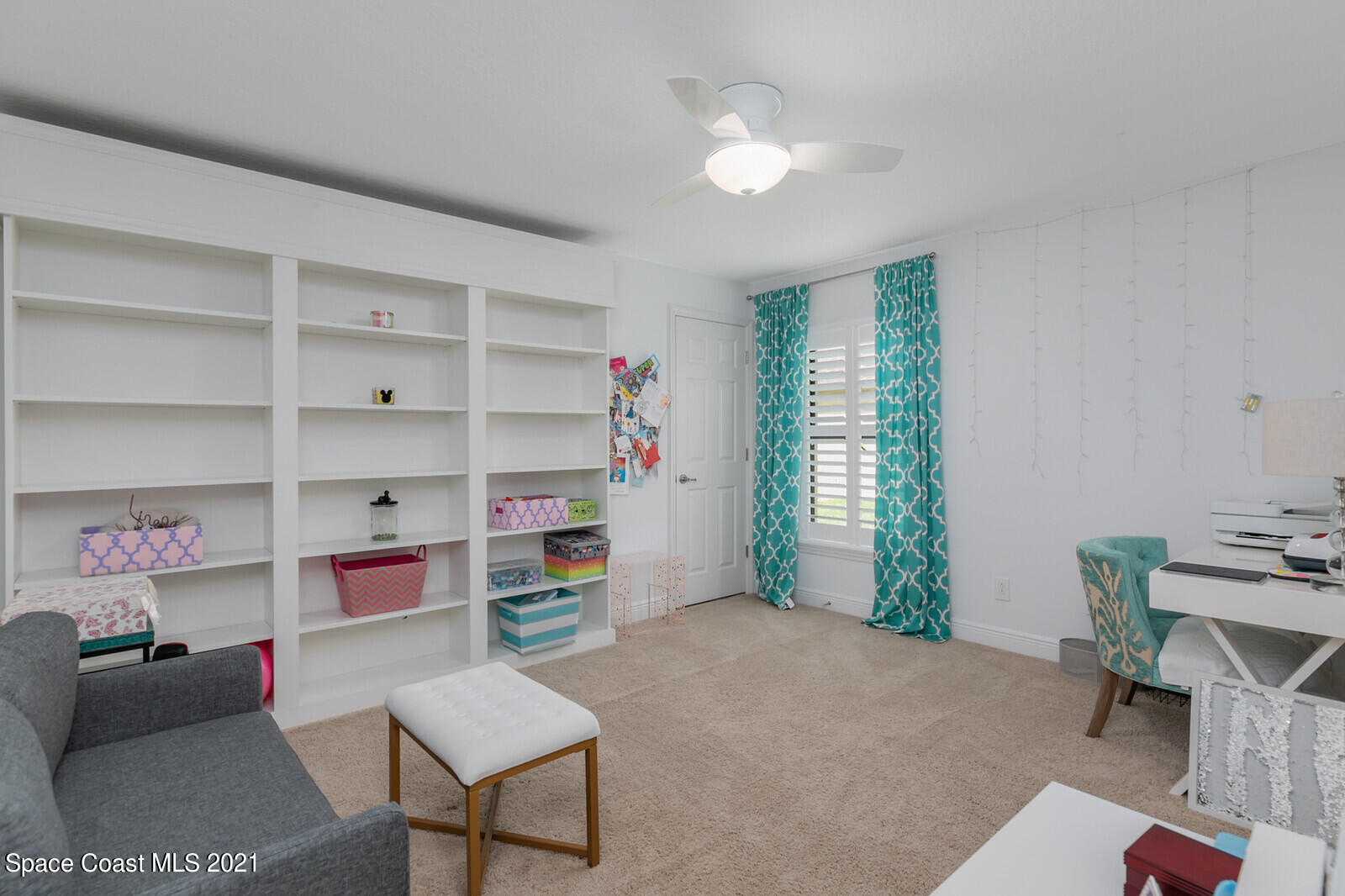 1398 Outrigger Circle Rockledge, FL 32955 - Photo 27 of 51 a living room with furniture and a book shelf