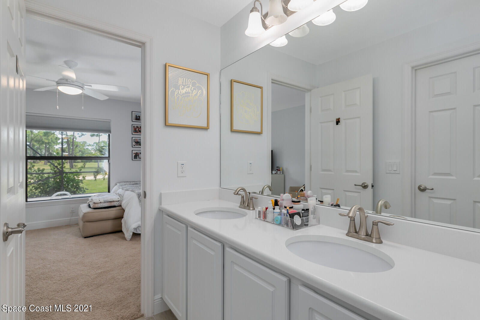 1398 Outrigger Circle Rockledge, FL 32955 - Photo 29 of 51 a bathroom with a double vanity sink window and a mirror