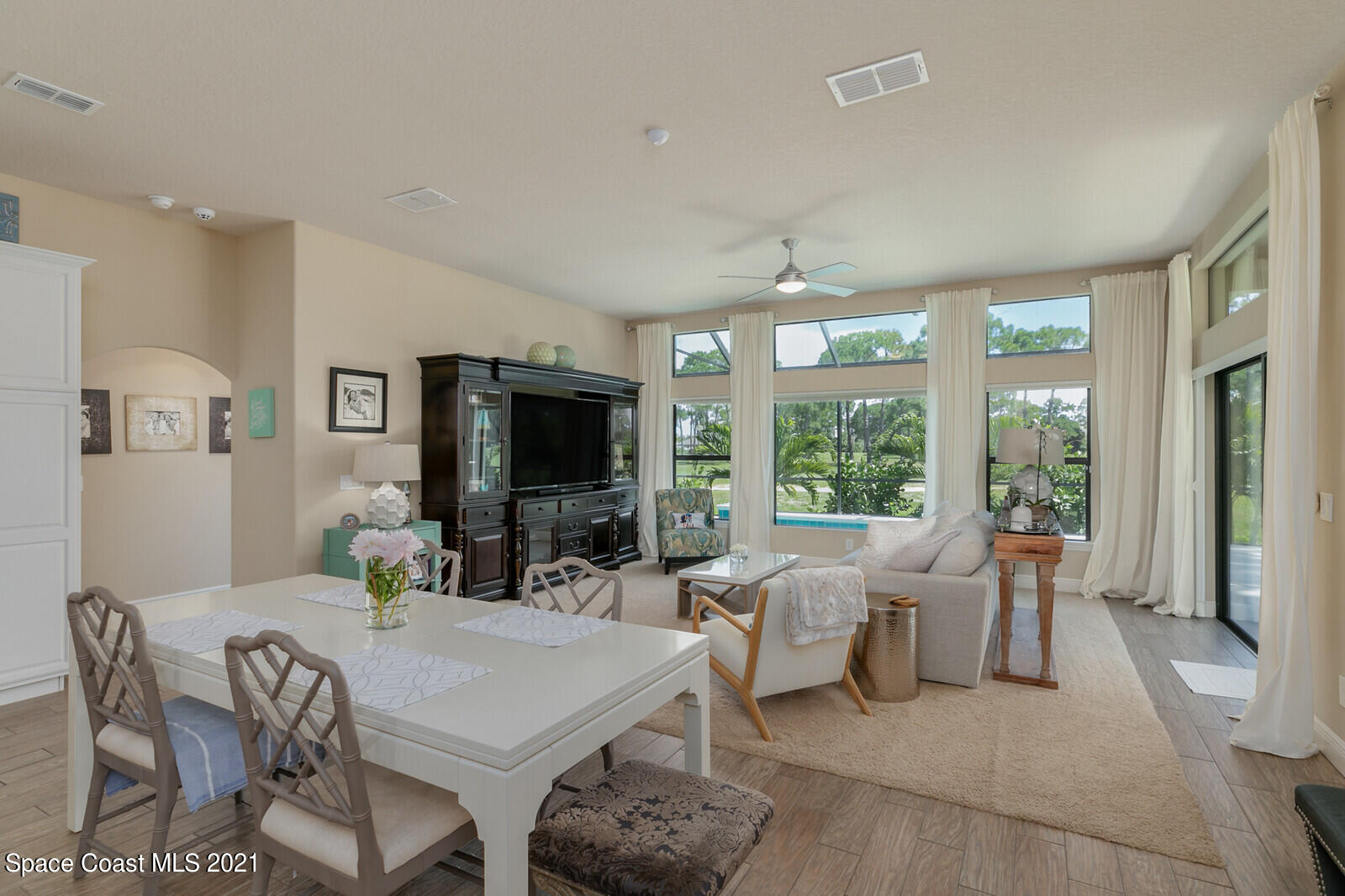 1398 Outrigger Circle Rockledge, FL 32955 - Photo 36 of 51 a living room with furniture a large window and a flat screen tv