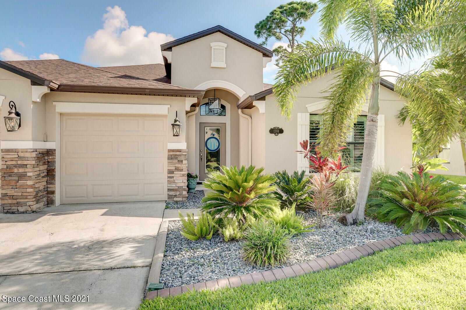 1398 Outrigger Circle Rockledge, FL 32955 - Photo 5 of 51 a front view of a house with garden