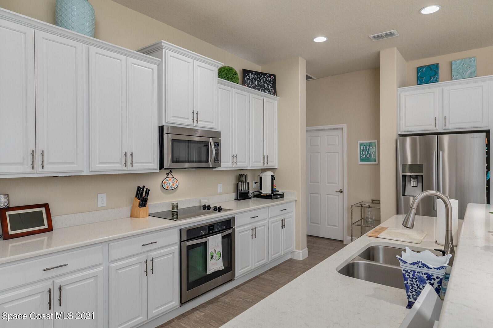 1398 Outrigger Circle Rockledge, FL 32955 - Photo 44 of 51 a kitchen with stainless steel appliances granite countertop a refrigerator sink and white cabinets