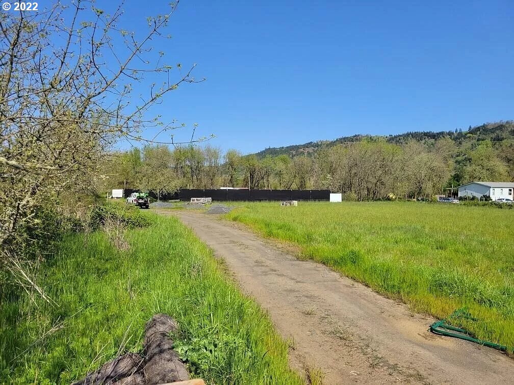 502 Meadow View Road Roseburg, OR 97471 - Photo 2 of 4 a view of a grassy field with an trees