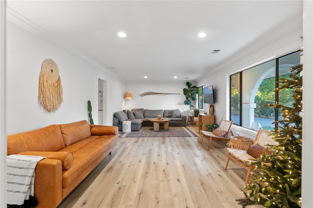 736 Del Valle Drive Fallbrook, CA 92028 - Photo 12 of 53 a living room with furniture floor to ceiling window and wooden floor