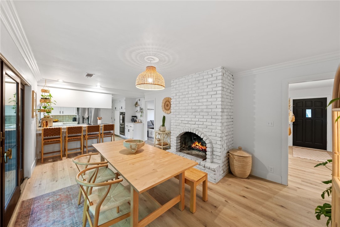 736 Del Valle Drive Fallbrook, CA 92028 - Photo 18 of 53 a view of a dining room with furniture wooden floor and a fireplace
