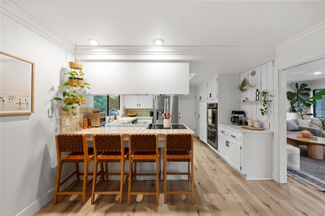736 Del Valle Drive Fallbrook, CA 92028 - Photo 22 of 53 a large white kitchen with a table and chairs