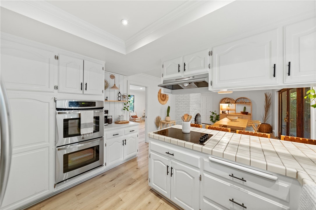 736 Del Valle Drive Fallbrook, CA 92028 - Photo 26 of 53 a kitchen with white cabinets and white appliances