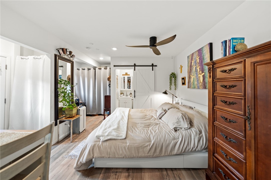 736 Del Valle Drive Fallbrook, CA 92028 - Photo 42 of 53 a spacious bedroom with a bed a dresser and a book shelf