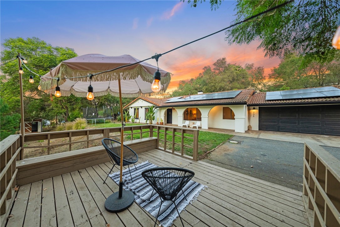 736 Del Valle Drive Fallbrook, CA 92028 - Photo 10 of 53 a view of a roof deck with table and chairs with wooden floor
