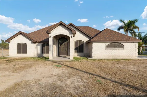 a view of a house with a yard and garage