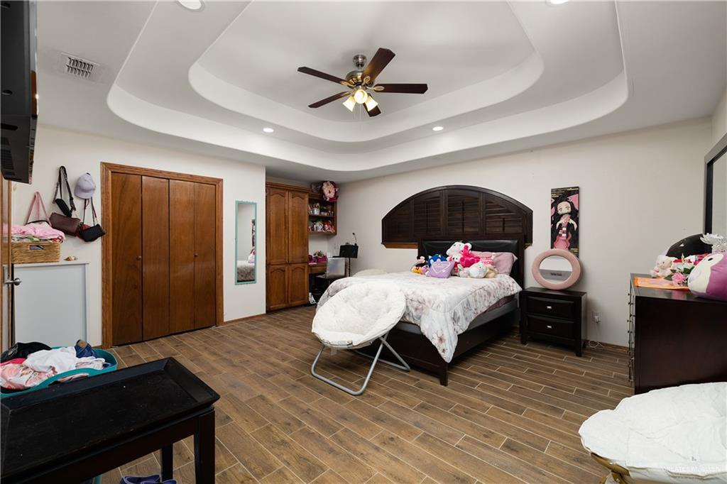 704 Goodwin Acres Road Mission, TX 78574 - Photo 15 of 26 a bed room with a bed and a chandelier