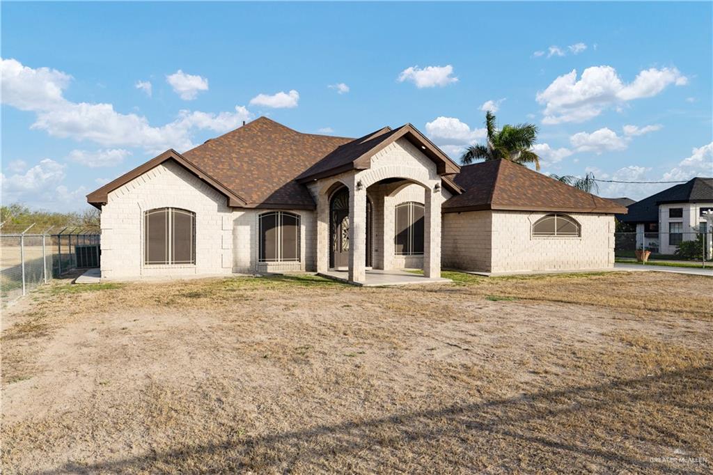 704 Goodwin Acres Road Mission, TX 78574 - Photo 2 of 26 a view of a house with a yard