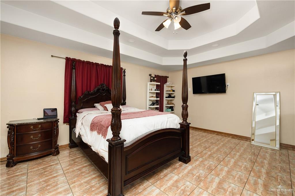 704 Goodwin Acres Road Mission, TX 78574 - Photo 10 of 26 a bed room with a bed and a television