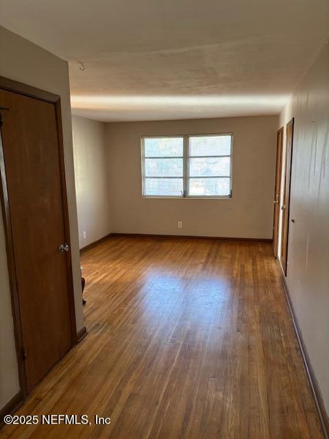 2898 Olga Place, Unit 3 Jacksonville, FL 32205 - Photo 2 of 8 an empty room with wooden floor and windows