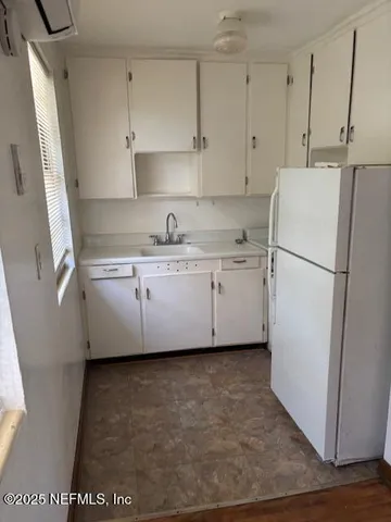 a kitchen with stainless steel appliances a refrigerator sink and cabinets
