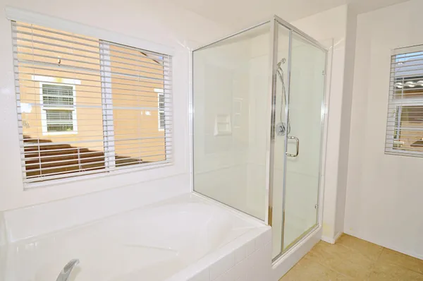 a bathroom with a shower and a window