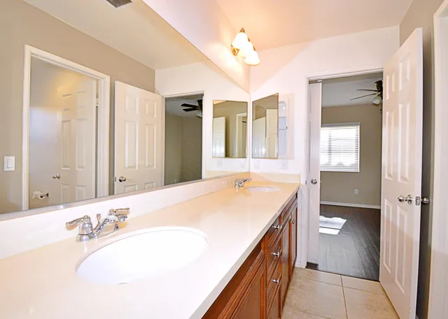a bathroom with a tub sink and mirror
