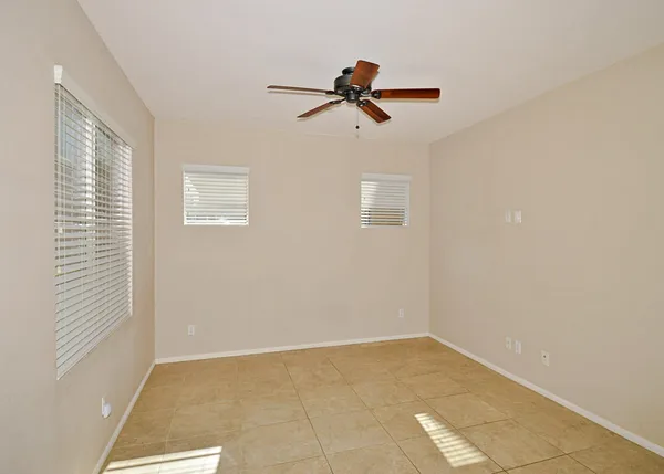 a view of room with window and a ceiling fan
