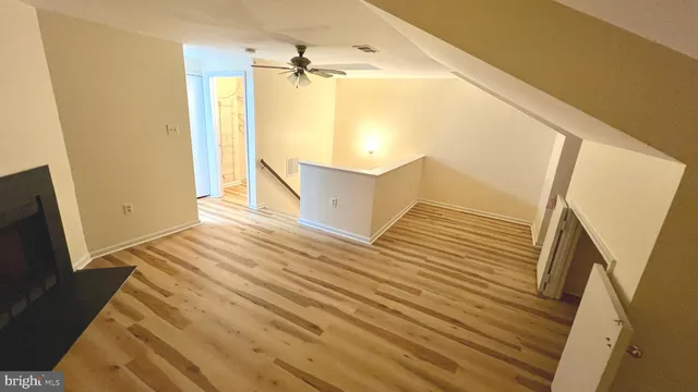 a view of a room with wooden floor and staircase