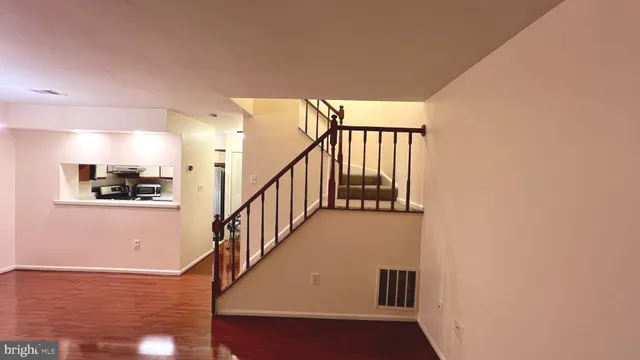 a view of staircase with lots of frames and white walls