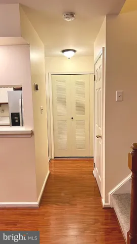 a view of a hallway with wooden floor