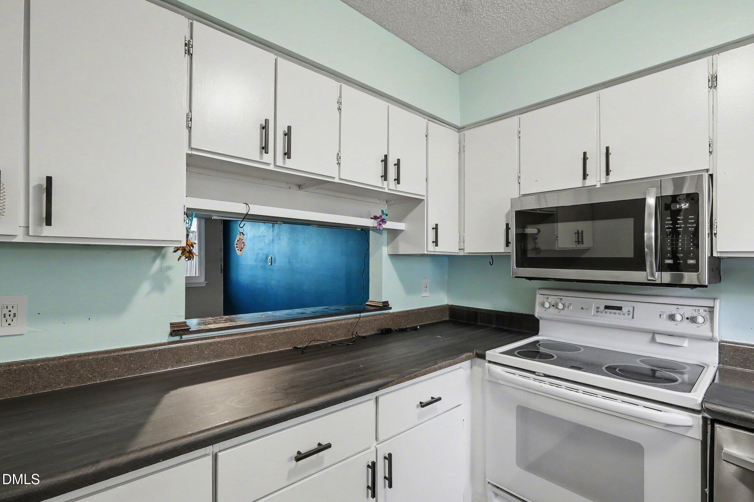 4271 Lake Ridge Drive Raleigh, NC 27604 - Photo 17 of 36 a kitchen with granite countertop white cabinets stainless steel appliances and a sink