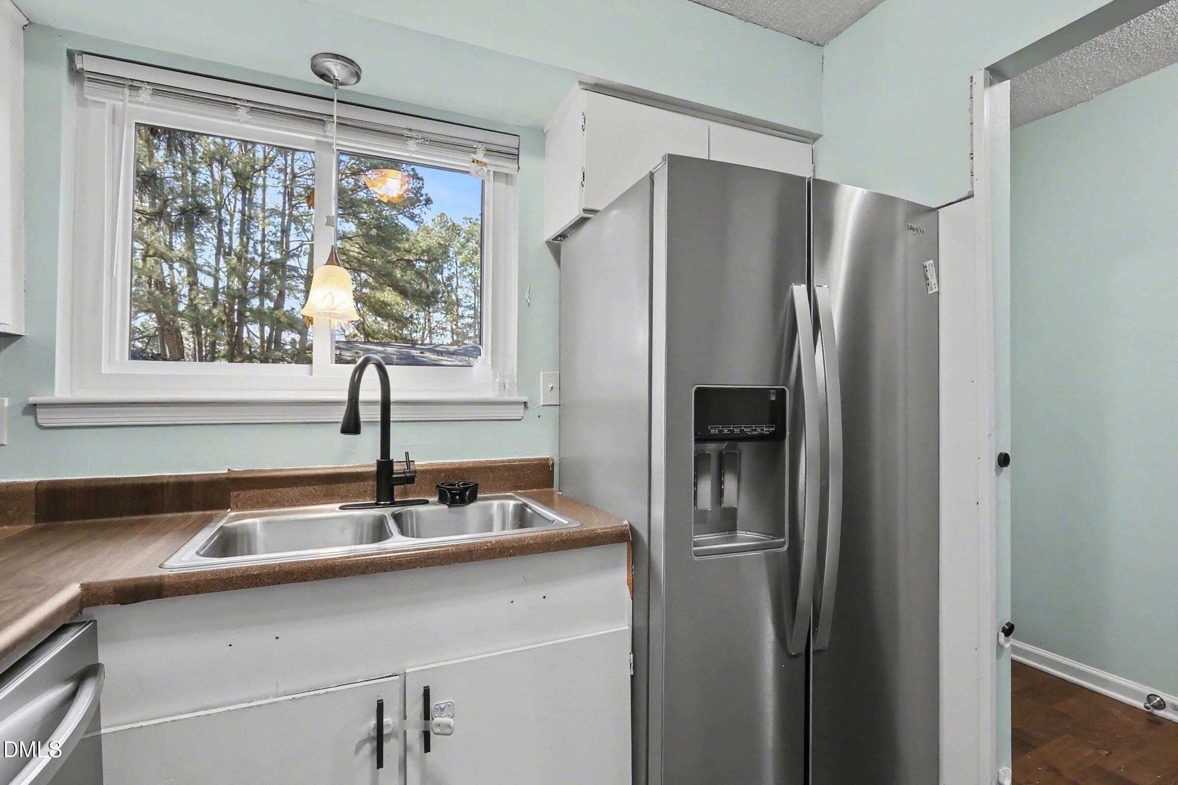 4271 Lake Ridge Drive Raleigh, NC 27604 - Photo 18 of 36 a kitchen with a sink and a refrigerator