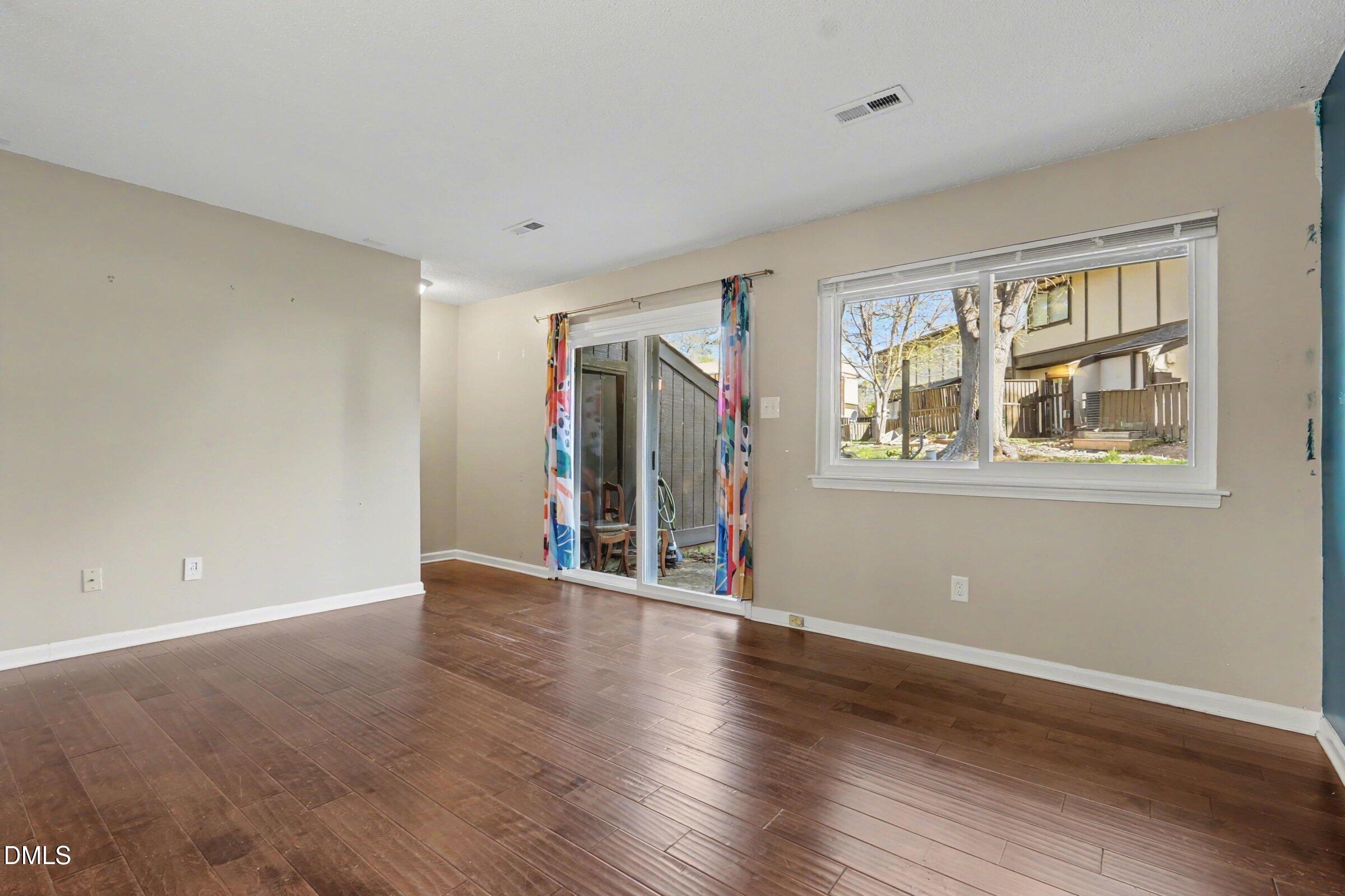 4271 Lake Ridge Drive Raleigh, NC 27604 - Photo 19 of 36 a view of an empty room with wooden floor and a window
